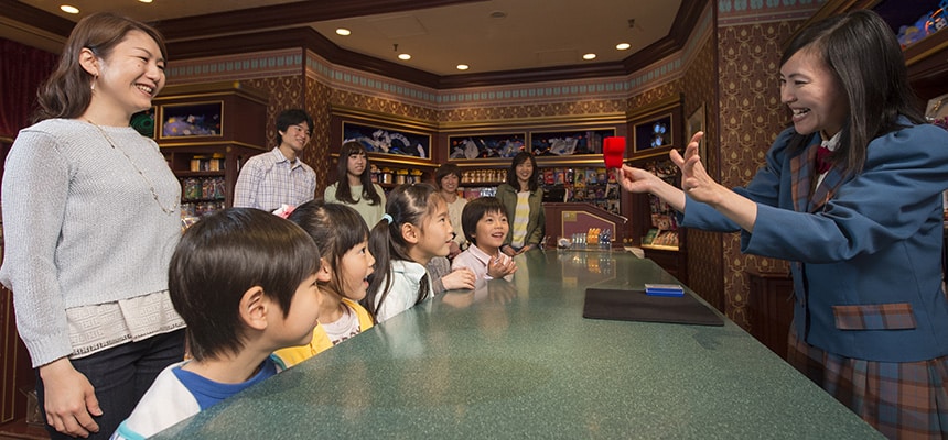 Demonstrations and illusions always draw an appreciative audience in the Magic Shop at Tokyo Disneyland. © Disney