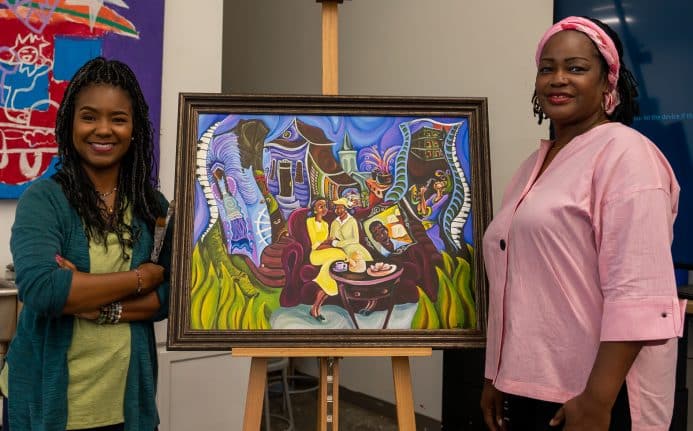 New Orleans artist Sharika Mahdi smiles with her artwork