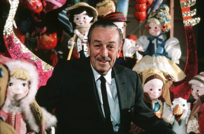 Walt Disney with dolls from "it's a small world"