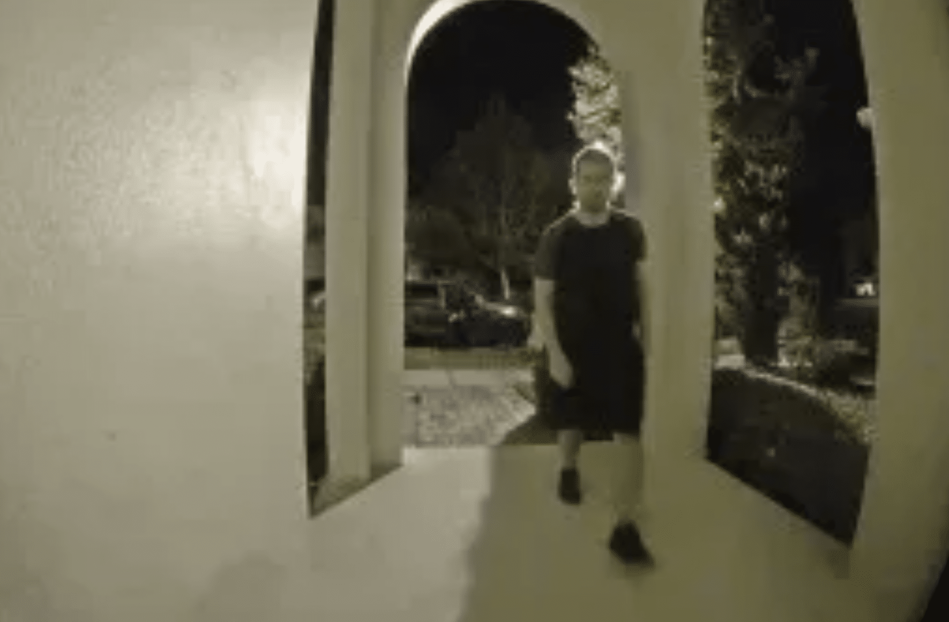 Fired Disney employee Michael Scheuer approaches the home of a Disney employee he allegedly targeted in cyberattacks late at night. (Courtesy of FBI)