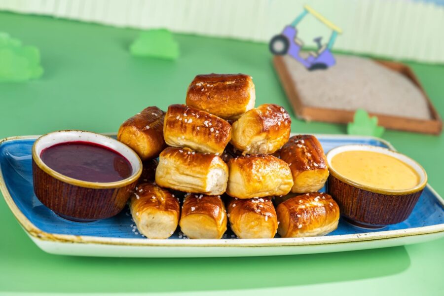 IMG1709 | The Main Street Mouse Pile of Glossy Pretzel Bites Stacked on a Blue Tray with Two Dipping Sauces red and Yellow on the Side