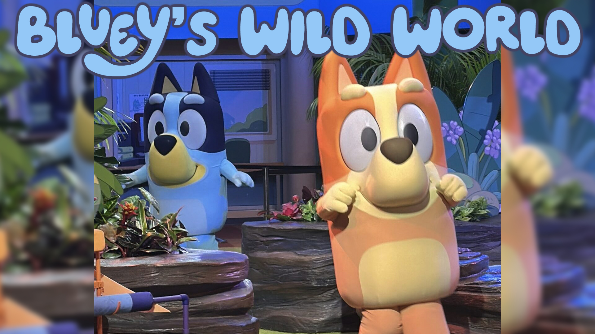Two Large Cartoon Dogs Stand in a Colorful Outdoor Display Under the blueys World Banner