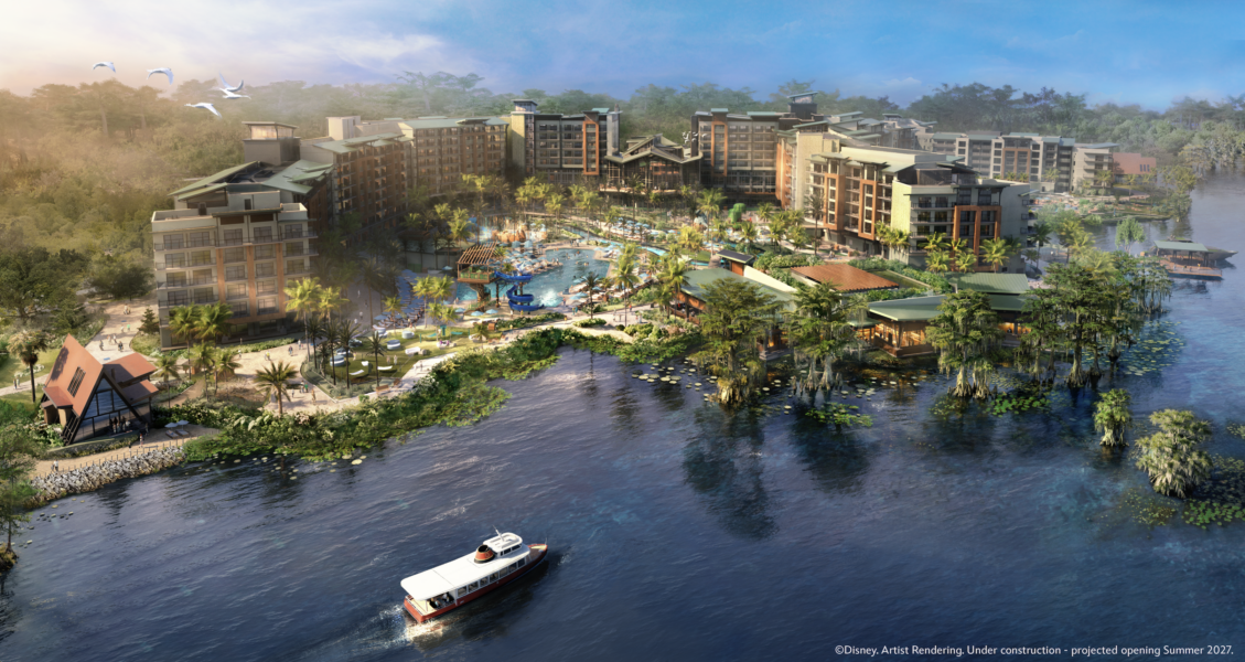 Disney Lakeshore Lodge | The Main Street Mouse Large resort complex with palm trees a central pool area multiple buildings and a boat on a surrounding lagoon