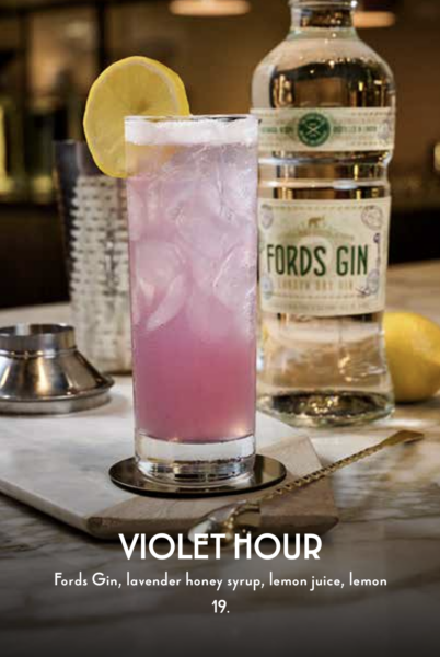 Violet Hour | The Main Street Mouse Pink Lavender Cocktail with a Lemon Wedge Beside a Fords Gin Bottle on a Bar Top
