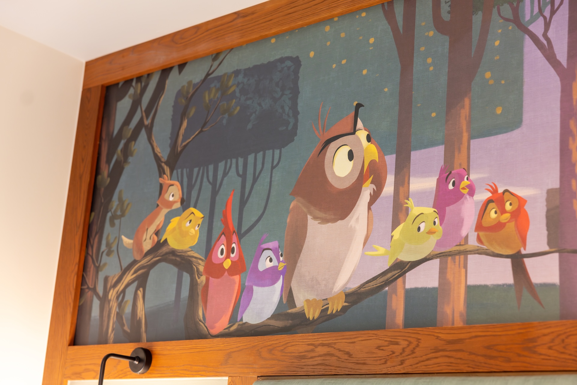 2026DVCReimaginedTreehouseVillas2 | The Main Street Mouse Framed Mural of Colorful Cartoon Birds Perched on Branches in a Forest Scene