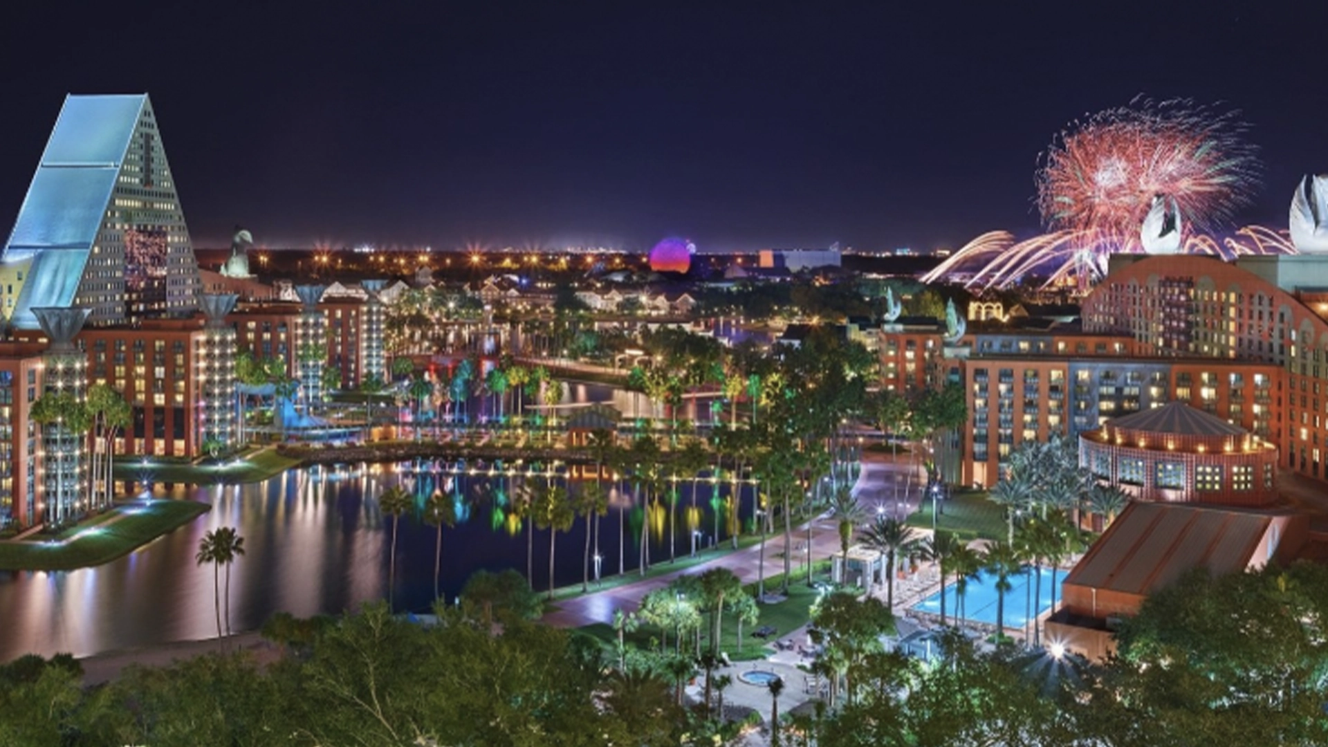 Walt Disney World Swan and Dolphin Celebrating America 250 with July 4th Party Summer Concerts and Exclusive Hotel Deals | The Main Street Mouse Night Skyline of a Colorful City with Illuminated Buildings Palm Trees and a Fireworks Display over the Water