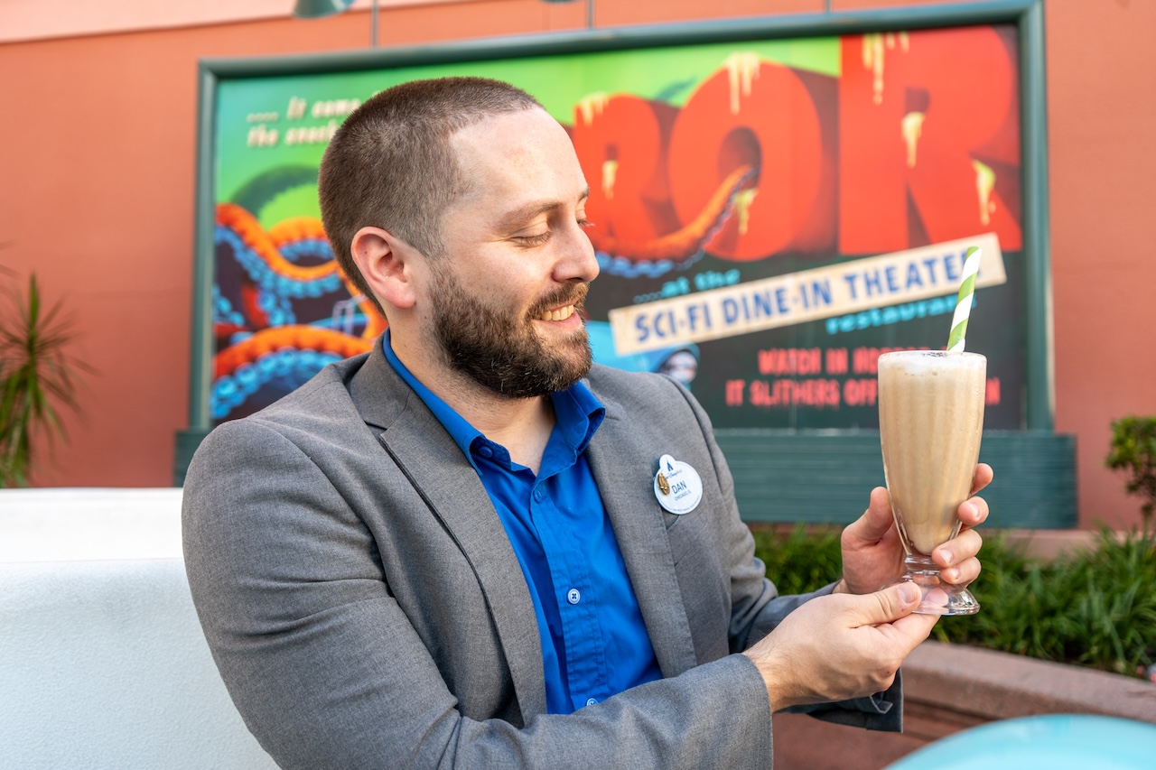 Disney World Cast Member Dan Laske Holding a Milkshake He Helped Develop